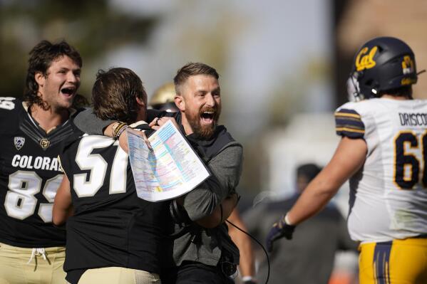 Colorado interim head coach Mike Sanford, third from left, celebrates with linebacker Thomas Notarianni, second from left, and tight end Louis Passarello, left, as California offensive lineman Brian Driscoll, right, walks off the field after overtime in an NCAA college football game in at Folsom Field, Saturday, Oct. 15, 2022, in Boulder, Colo. (AP Photo/David Zalubowski)