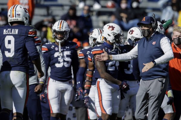 Auburn head coach Gus Malzahn reacts with players after a stop against Texas A&M during the first half of an NCAA college football game on Saturday, Dec. 5, 2020, in Auburn, Ala. (AP Photo/Butch Dill)