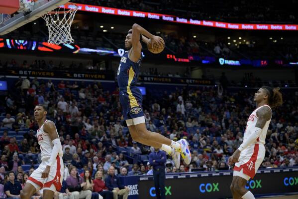 Houston Rockets guard Garrison Mathews (25) goes to the basket to dunk against the Houston Rockets during the first half of an NBA basketball game in New Orleans, Wednesday, Jan. 4, 2023. (AP Photo/Matthew Hinton)