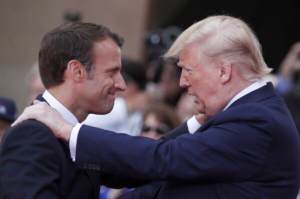 French President Emmanuel Macron, left, meets U.S President Donald Trump during a ceremony to mark the 75th anniversary of D-Day at the Normandy American Cemetery in Colleville-sur-Mer, Normandy, France, on June 6, 2019. (Ian Langsdon/Pool via AP, File)