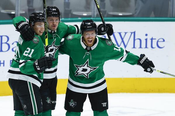 FILE - Dallas Stars forward Joe Pavelski, right, is congratulated by forwards Jason Robertson (21) and Roope Hintz (24) after scoring a goal during the first period of an NHL hockey game against the Seattle Kraken, Wednesday, April 12, 2022, in Dallas. Jason Robertson is a 40-goal scorer with almost as many assists in his second NHL season, and doesn't even have the most points on the top line for the Dallas Stars. Neither does fellow young 20-something forward Roope Hintz. Joe Pavelski is a point-a-game player at 37 years old, the grizzled veteran that is part of the the most-productive trio for the Stars since the team’s first season in Big D nearly three decades ago. (AP Photo/Brandon Wade, File)