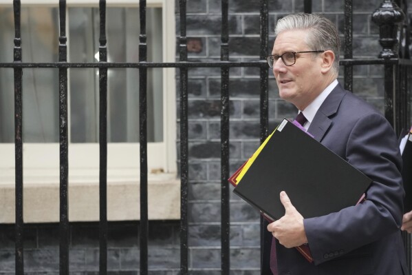FILE -Britain's Prime Minister Keir Starmer leaves 10 Downing Street to attend the weekly Prime Ministers' Questions session in parliament in London, Wednesday, June 11, 2025. (AP Photo/Kin Cheung, File)