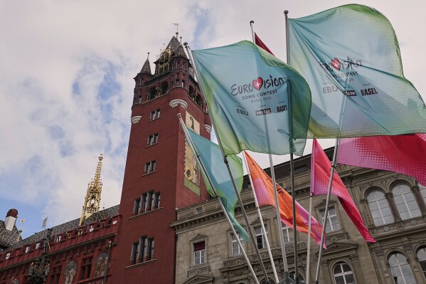 Eurovision flags wave in front of the 500-year-old Basel Town Hall in the city center ahead of the first semi-final of the 69th Eurovision Song Contest, in Basel, Switzerland, Tuesday, May 13, 2025. (AP Photo/Martin Meissner)