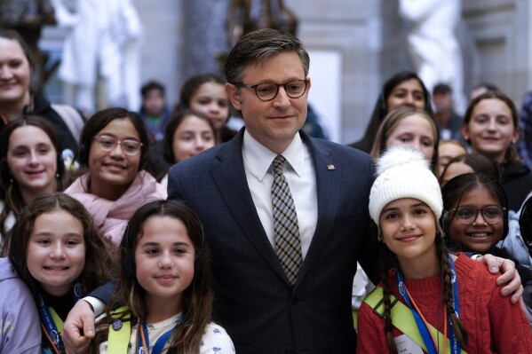 House Speaker Mike Johnson, R-La., poses for a group photo with children visiting Capitol Hill, Thursday, Jan. 18, 2024, in Washington. (AP Photo/Yuri Gripas)