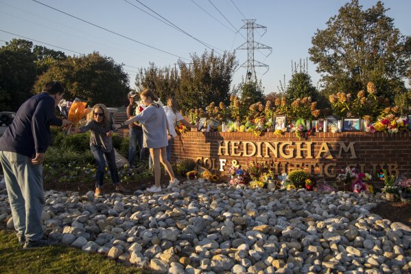 FILE - Raleigh's Hedingham neighborhood entrance sign becomes a makeshift memorial, Saturday, Oct. 15, 2022, following Thursday's mass shooting in the neighborhood and on the nearby Neuse River greenway trail. Nearly one year after a teenager killed five people and injured two others in a shooting rampage that rocked his quiet Raleigh neighborhood, suspect Austin Thompson is facing murder charges in adult court. (Travis Long/The News & Observer via AP, File)