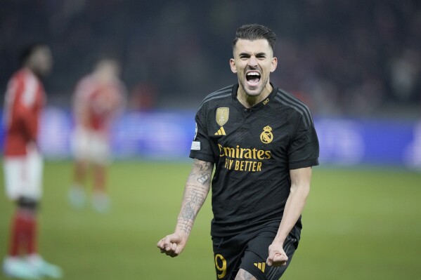 Real Madrid's Dani Ceballos celebrates after scoring his side's third goal during the Champions League group C soccer match between Union Berlin and Real Madrid at the Olympiastadion in Berlin, Tuesday, Dec. 12, 2023. (AP Photo/Markus Schreiber)