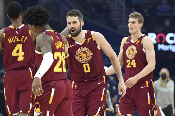 FILE - Cleveland Cavaliers' Kevin Love (0) celebrates with Brandon Goodwin (26) in the first half of an NBA basketball game against the Indiana Pacers, Sunday, Jan. 2, 2022, in Cleveland. Once an All-Star, Love's now a $30 million-per-year role player relishing his niche. (AP Photo/Nick Cammett, File)