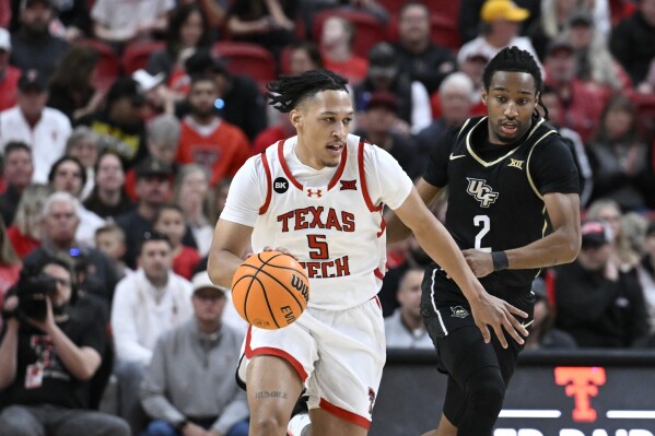 Texas Tech guard Darrion Williams (5) brings the ball up court against Central Florida guard Shemarri Allen (2) during the first half of an NCAA college basketball game, Saturday, Feb. 10, 2024, in Lubbock, Texas. (AP Photo/Justin Rex)
