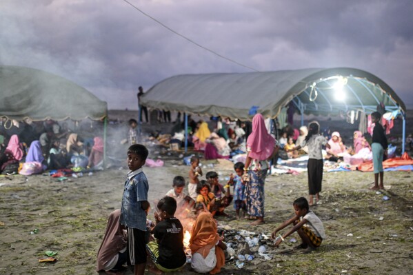 Ethnic Rohingya play at their camp in Pidie, Aceh province, Indonesia, Friday, Dec. 15, 2023. The Associated Press has interviewed five Rohingya refugees who were rescued from the first boat and arrived in Indonesia, revealing a few clues about the fate of the other boat, now missing for weeks. Until now, almost nothing was known about the vanished vessel, beyond that it left Bangladesh in November. (AP Photo/Reza Saifullah)