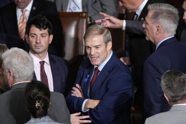 Rep. Jim Jordan, R-Ohio, chairman of the House Judiciary Committee, talks with members as the House convenes for a second day of balloting to elect a speaker, at the Capitol in Washington, Wednesday, Oct. 18, 2023. Former Speaker Rep. Kevin McCarthy, R-Calif., looks on at right. (AP Photo/J. Scott Applewhite)
