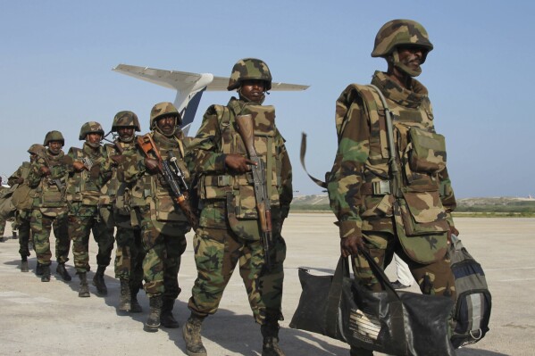 FILE - Djiboutian forces walk inline during their arrival in Mogadishu, Somalia, on Dec. 20, 2011. The United Nations Security Council on Thursday Nov. 9, 2023 suspended for a period of three months the pullout of African Union troop from Somalia, where fighting rages with al-Qaida’s affiliate in East Africa. The decision follows a request by the Horn of Africa nation for the forces to remain in the country to help in the fight against the al-Shabab extremists. (AP Photo/Farah Abdi Warsameh, File)