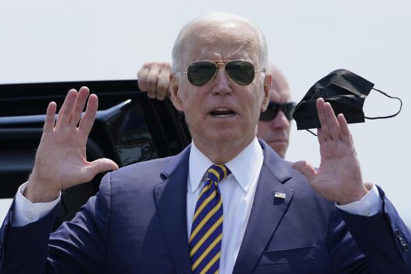 President Joe Biden holds a mask as he responds to a question as he arrives at Lehigh Valley International Airport in Allentown, Pa., Wednesday, July 28, 2021. Biden is in the area to visit the Lehigh Valley operations facility for Mack Trucks and advocate for government investments and clean energy as ways to strengthen U.S. manufacturing. (AP Photo/Susan Walsh)