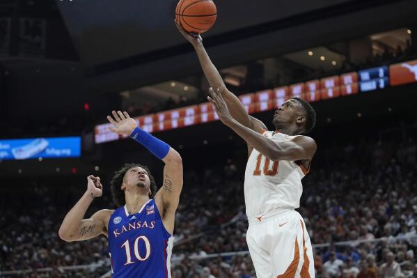 Texas guard Sir'Jabari Rice, right, drives to the basket against Kansas forward Jalen Wilson, left, during the second half of an NCAA college basketball game in Austin, Texas, Saturday, March 4, 2023. (AP Photo/Eric Gay)