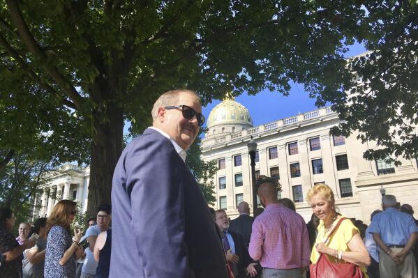 FILE - Former coal executive Don Blankenship waits outside the West Virginia Capitol on Wednesday, Aug. 29, 2018, after the Capitol was evacuated due to a fire alarm in Charleston, W.Va. Three reporters from a Pulitzer Prize-winning newspaper in West Virginia have been fired after publicly criticizing a now-removed video interview posted on their parent company's website with a former coal executive who was convicted of a safety violation in connection with the worst U.S. mine disaster in decades. (AP Photo/John Raby, File)