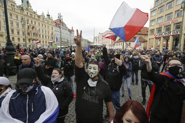 Demonstrators gather to protest the COVID-19 preventative measures downtown Prague, Czech Republic, Wednesday, Oct. 28, 2020. Coronavirus infections in the Czech Republic have again jumped to record levels amid new restrictive measures imposed by the government to curb the spread. (AP Photo/Petr David Josek)