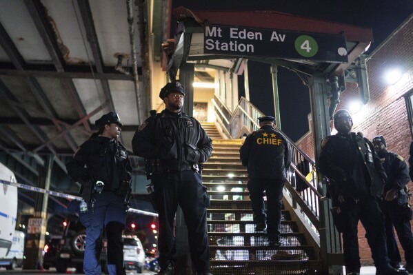 New York City Police officers stand guard following a shooting at the Mount Eden subway station, Monday, Feb. 12, 2024, in the Bronx borough of New York. Police said one 35-year-old man died after being shot in the chest, and the other five victims, ranging in age from the teens to the 70s, are expected to recover from their gunshot wounds. Two teenage boys and one teenage girl were shot in their extremities, as was a 71-year-old, shot in the thumb. One woman, 29, was shot in the face and neck. (AP Photo/Eduardo Munoz Alvarez)