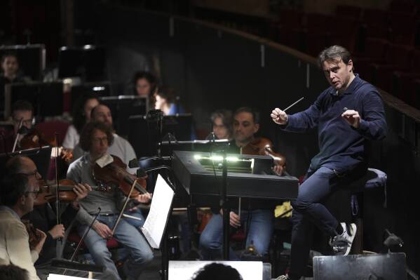 Michele Mariotti, right, director of the "Teatro dell' Opera" opera house orchestra, practices in Rome, Thursday, April 10, 2025. (AP Photo/Andrew Medichini)