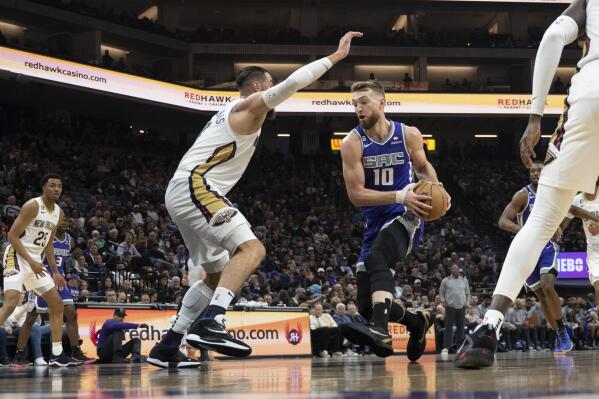 Sacramento Kings forward Domantas Sabonis (10) is defended by New Orleans Pelicans center Jonas Valanciunas in the first quarter in an NBA basketball game in Sacramento, Calif., Saturday, March 6, 2023. (AP Photo/José Luis Villegas)