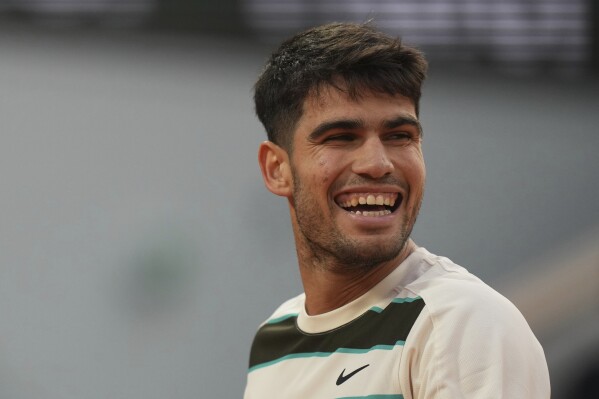 Spain's Carlos Alcaraz smiles as he plays against Tommy Paul of the U.S. during their quarterfinal match of the French Tennis Open at the Roland-Garros stadium in Paris, Tuesday, June 3, 2025. (AP Photo/Thibault Camus)