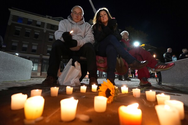 FILE - Community members gather Thursday, Nov. 2, 2023, during a candlelight vigil in Auburn, Maine. Maine's government is going to cover the cost of funerals for families who lost loved ones in the deadliest mass shootings in the state's history, the office of Gov. Janet Mills said Wednesday, Nov. 8. (AP Photo/Matt York)