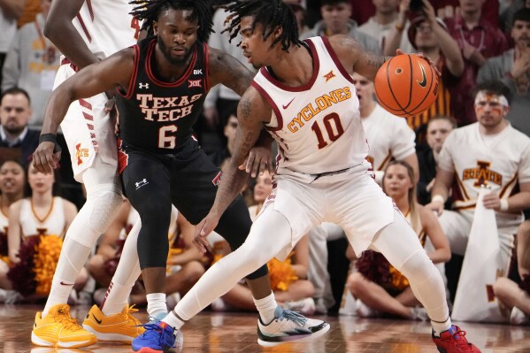 Iowa State guard Keshon Gilbert (10) drives the ball inside as Texas Tech guard Joe Toussaint (6) defends in the first half during an NCAA college basketball game, Saturday, Feb. 17, 2024, in Ames, Iowa. (AP Photo/Bryon Houlgrave)