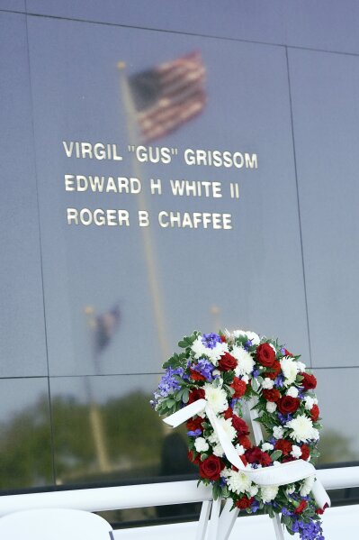 A wreath placed at the base of the Space Mirror Memorial stands during a ceremony to honor fallen astronauts at the Kennedy Space Center Visitors Complex, Thursday, Jan. 28, 2021, in Cape Canaveral, Fla. The memorial displays the names of astronauts that lost their lives furthering the cause of space exploration. (AP Photo/John Raoux)