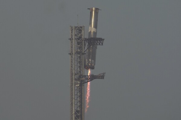 The booster of SpaceX's mega rocket Starship is recaptured during a test flight from Starbase in Boca Chica, Texas, Thursday, March 6, 2025. (AP Photo/Eric Gay)