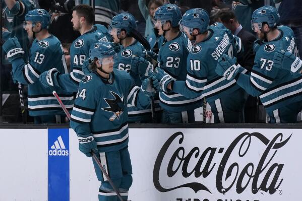 San Jose Sharks left wing Alexander Barabanov, foreground, is congratulated by teammates after scoring against the Buffalo Sabres during the second period of an NHL hockey game in San Jose, Calif., Saturday, Feb. 18, 2023. (AP Photo/Jeff Chiu)