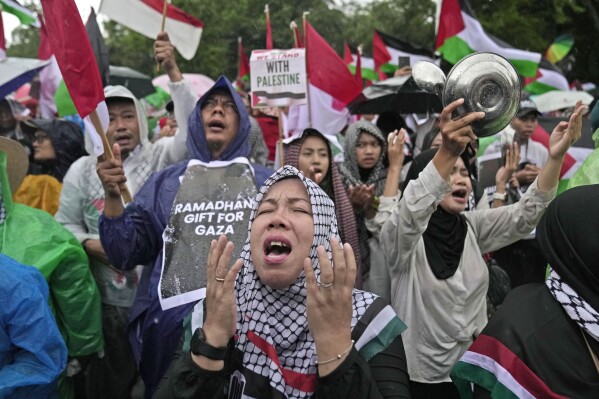 Women chant slogans during a rally in support of the Palestinians in Gaza, outside the U.S. Embassy in Jakarta, Indonesia, Saturday, March 9, 2024. (AP Photo/Dita Alangkara)