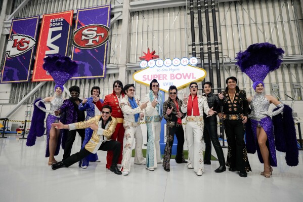 Elvis impersonators and showgirls pose in preparation for team arrivals ahead of the NFL Super Bowl 58 football game between the San Francisco 49ers and the Kansas City Chiefs Sunday, Feb. 4, 2024, in Las Vegas. Las Vegas is scheduled to host the Super Bowl 58 on Sunday, Feb. 11, 2024. (AP Photo/David J. Phillip)