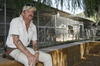 FILE - In this Aug. 28, 2013, file photo, Joseph Maldonado-Passage, also known as Joe Exotic, is seen at the zoo he used to run in Wynnewood, Okla. A federal judge in Oklahoma has ordered the new owners of the Oklahoma zoo featured in Netflix's "Tiger King" documentary to turn over all the lion and tiger cubs in their possession, along with the animals' mothers, to the federal government. U.S. District Judge John F. Heil III issued the order last week in the case against Jeffrey and Lauren Lowe and the Greater Wynnewood Exotic Animal Park based on claimed violations of the Endangered Species Act and the Animal Welfare Act. (AP Photo/Sue Ogrocki, File)