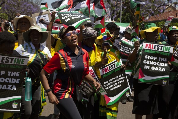 FILE - Pro-Palestinian supporters demonstrate at the entrance to the Israeli embassy in Pretoria, South Africa, on Oct. 20, 2023. South Africa's government has recalled Monday Nov. 6, 2023 its ambassador and diplomatic mission to Israel in condemnation of the bombardment of the Gaza Strip, calling it “a genocide”. (AP Photo/Denis Farrell, File)