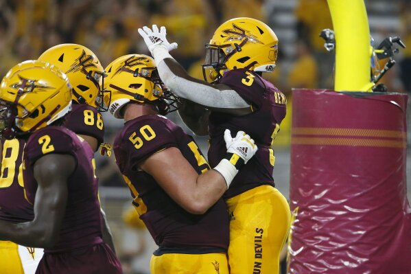 Arizona State running back Eno Benjamin (3) celebrates with teammate Jarrett Bell (50) after scoring a touchdown against Kent State during the first half of an NCAA college football game Thursday, Aug. 29, 2019, in Tempe, Ariz. (AP Photo/Ralph Freso)