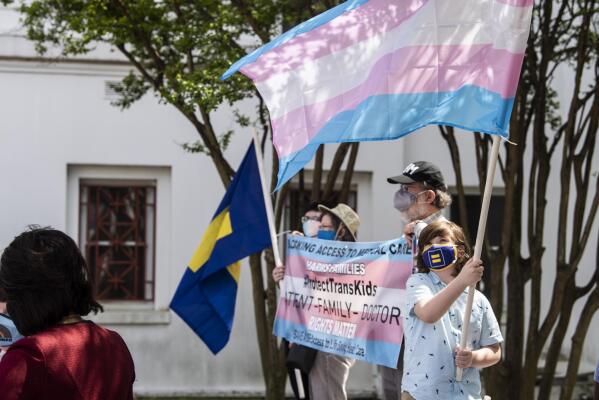 Protestors in support of transgender rights rally outside the Alabama State House in Montgomery, Ala., on Tuesday, March 30, 2021.  (Jake Crandall/The Montgomery Advertiser via AP)