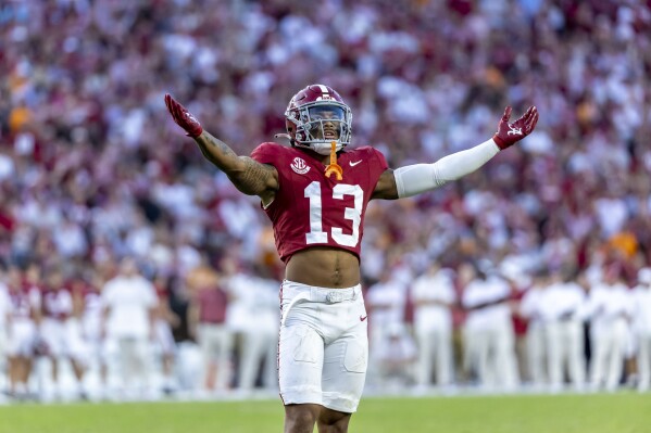 Alabama defensive back Malachi Moore (13) salutes the fans during the second half of an NCAA college football game against Tennessee, Saturday, Oct. 21, 2023, in Tuscaloosa, Ala. (AP Photo/Vasha Hunt)