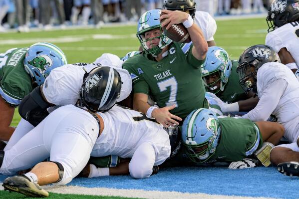 Tulane quarterback Michael Pratt (7) scores a touchdown in the first half during an NCAA college football game against UCF in New Orleans, Saturday, Nov. 12, 2022. (AP Photo/Matthew Hinton)