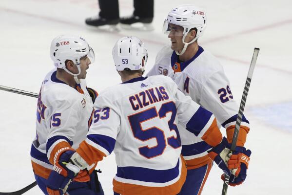 New York Islanders' Brock Nelson (29) celebrates after his empty-net goal with teammates Cal Clutterbuck (15) and Casey Cizikas (53) during third-period NHL hockey game action against the Ottawa Senators in Ottawa, Ontario, Monday, Nov. 14, 2022. (Patrick Doyle/The Canadian Press via AP)