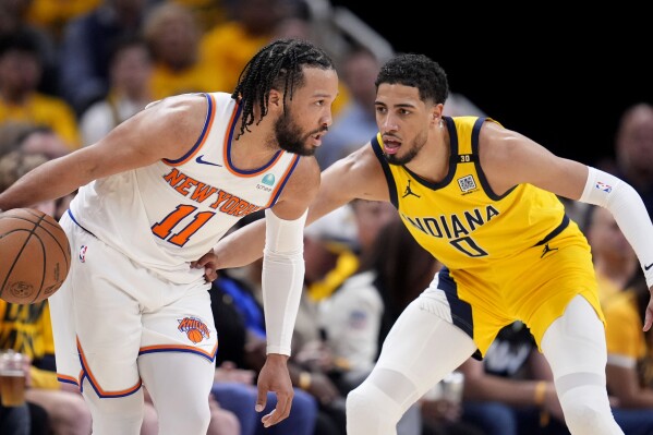 New York Knicks guard Jalen Brunson (11) drives past Indiana Pacers guard Tyrese Haliburton (0) during the second half of Game 3 in an NBA basketball second-round playoff series, Friday, May 10, 2024, in Indianapolis. (AP Photo/Michael Conroy, File)