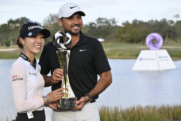 Lydia Ko, left, and Jason Day, right, celebrate with the championship trophy after winning the Grant Thornton Invitational, the first mixed-team golf tournament since 1999, Sunday, Dec. 10, 2023, in Naples, Fla. (AP Photo/Steve Nesius)