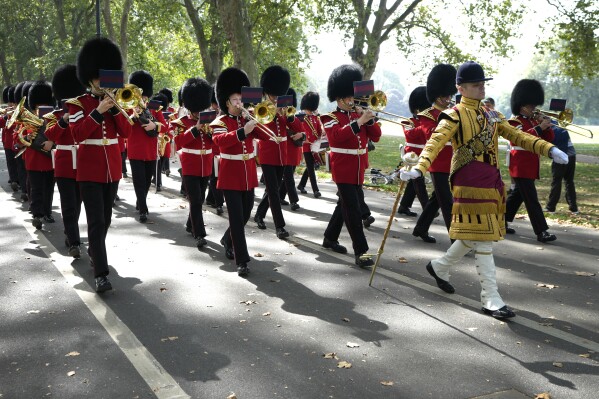 The Band of the Grenadier Guards marches in support of the King's Troop Royal Horse Artillery as they fire a 41-gun Royal Salute on the first anniversary of the death of Queen Elizabeth II, Friday, September 8, 2023, in Hyde Park, London. (AP Photo/Kirsty Wigglesworth)