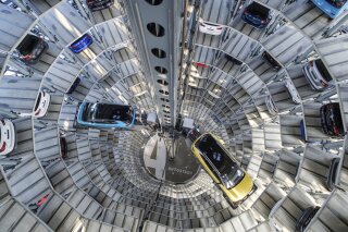 A Volkswagen ID.3 (l) and ID.4 stand inside a delivery tower in Wolfsburg, Germany, Friday, March 26, 2021. Volkswagen started deliveries of the all-electric SUV on 26 March 2021. (Ole Spata/dpa via AP)