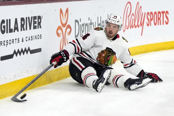 Chicago Blackhawks left wing Boris Katchouk tries to gather the puck after falling down in the second period during an NHL hockey game against the Arizona Coyotes, Tuesday, Feb. 28, 2023, in Tempe, Ariz. (AP Photo/Rick Scuteri)