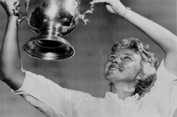FILE - This July 13, 1964, file photo shows Mickey Wright with her fourth U.S. Open Women's Golf Championship trophy after defeating Ruth Jessen 72-70 in an 18-hole playoff at San Diego Country Club.  Sports in 2020 was an unending state of mourning. It was as if every week, sometimes days, another luminary fell, bringing a cascade of condolence and remembrance. (AP Photo/File)