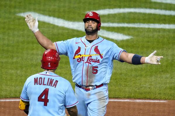 St. Louis Cardinals' Albert Pujols (5) is greeted by Yadier Molina (4) after hitting a two-run home run off Pittsburgh Pirates starting pitcher JT Brubaker during the sixth inning of a baseball game in Pittsburgh, Saturday, Sept. 10, 2022. (AP Photo/Gene J. Puskar)