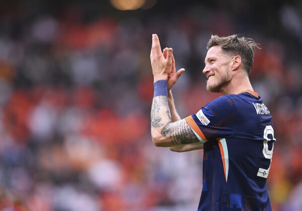 Wout Weghorst of the Netherlands applauds after a Group D match between Poland and the Netherlands at the Euro 2024 soccer tournament in Hamburg, Germany, Sunday, June 16, 2024. (Sina Schuldt/dpa via AP)