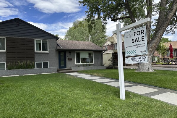 A for sale sign stands outside a single-family home Thursday, June 27, 2024, in Englewood, Colo. (AP Photo/David Zalubowski, File)