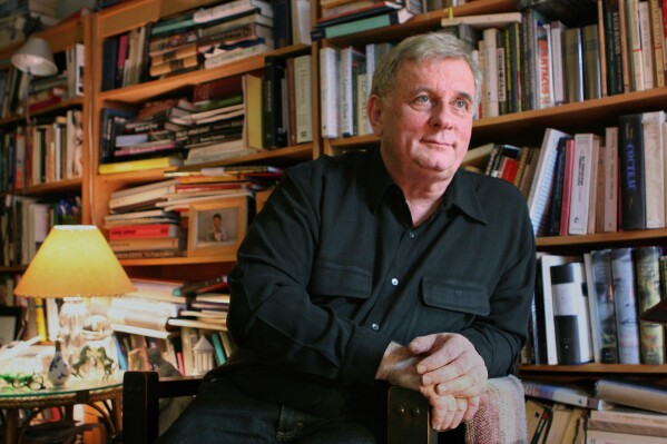 Author Edmund White appears in his New York apartment on April 24, 2006. (AP Photo/Mark Lennihan, File)