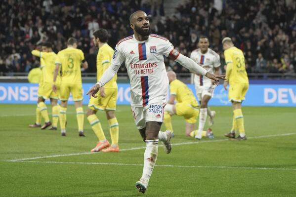 Lyon's Alexandre Lacazette celebrates after scoring his side's opening goal during the French League One soccer match between Lyon and Nantes at the Groupama stadium, in Decines, near Lyon, France, Friday, March 17, 2023. (AP Photo/Laurent Cipriani)