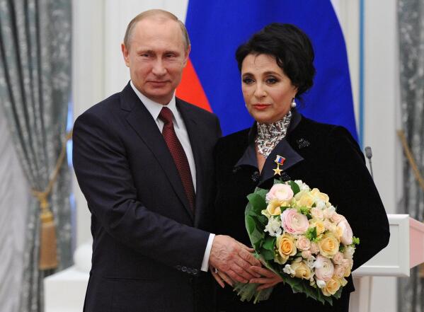 FILE - Russian President Vladimir Putin presents a medal to Head of the Russian Rhythmic Gymnastics Federation Irina Viner, in the Kremlin in Moscow, Russia, on May 1, 2015. Viner, whose athletes won numerous Olympic gold medals has been suspended, in a decision published late Monday, March 6, 2023 following vehement criticism of judges who ended Russia's winning streak in rhythmic gymnastics at the Tokyo Olympics. (Mikhail Klimentyev/RIA-Novosti, Kremlin Pool Photo via AP, File)