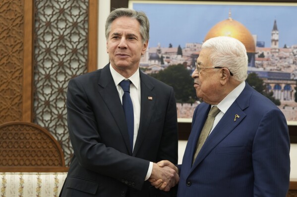 U.S. Secretary of State Antony Blinken, left, and Palestinian President Mahmoud Abbas shake hands during their meeting in the West Bank town of Ramallah, Wednesday, Feb. 7, 2024. (AP Photo/Mark Schiefelbein, Pool)